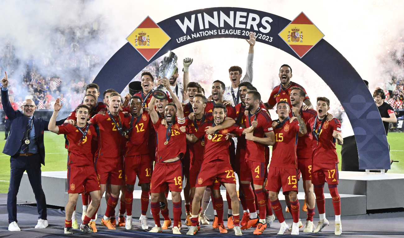 Spain's players and Spain's coach Luis de la Fuente (L) celebrate on the podium with the UEFA Nations League cup after winning the penalty shootouts and the UEFA Nations League final football match between Croatia and Spain at the De Kuip Stadium in Rotterdam on June 18, 2023. (AFP)
