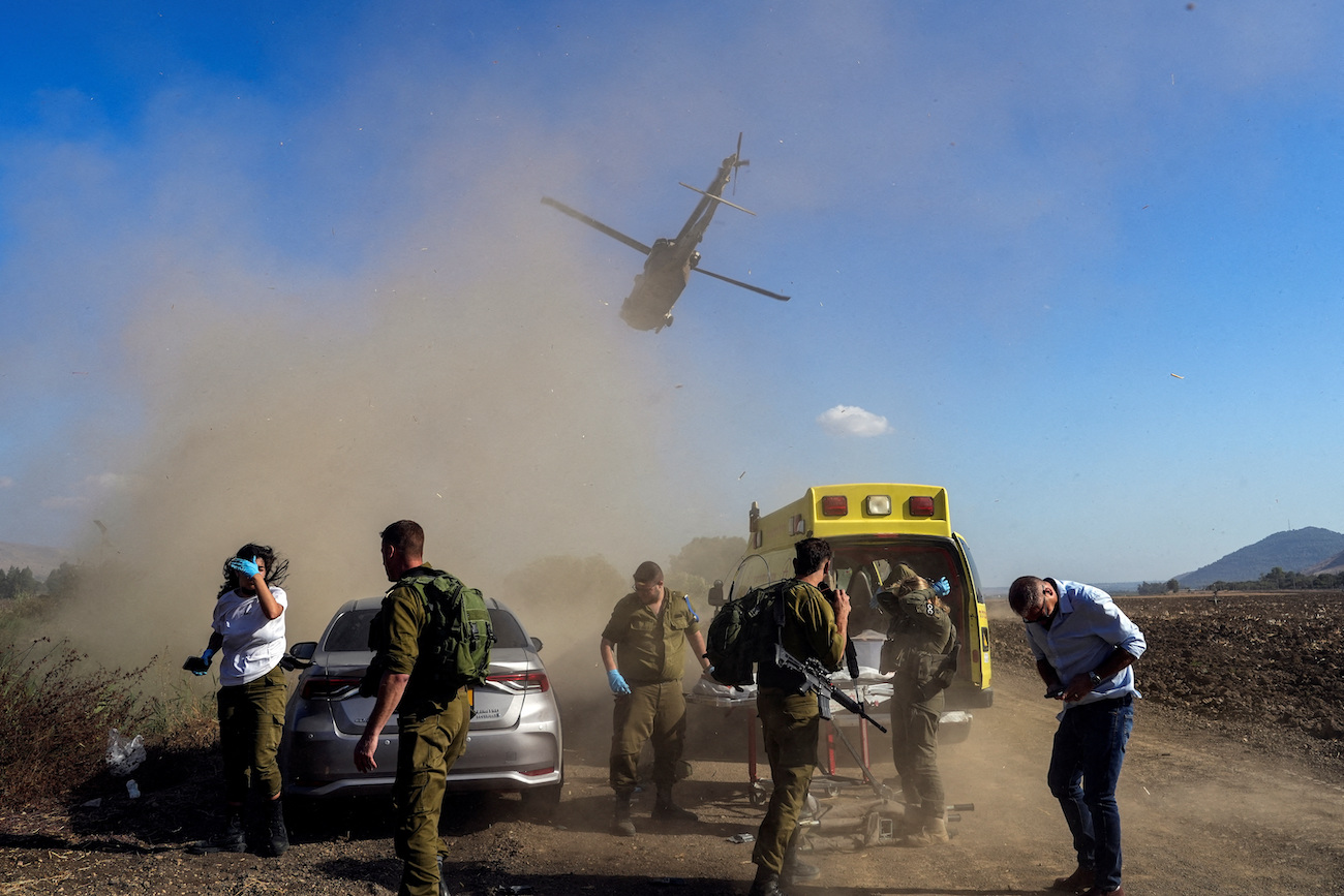 Israeli soldiers evacuate an injured man following a cross-border attack from Lebanon into Israel, on the Israeli side of the border, September 1, 2024. (Reuters)