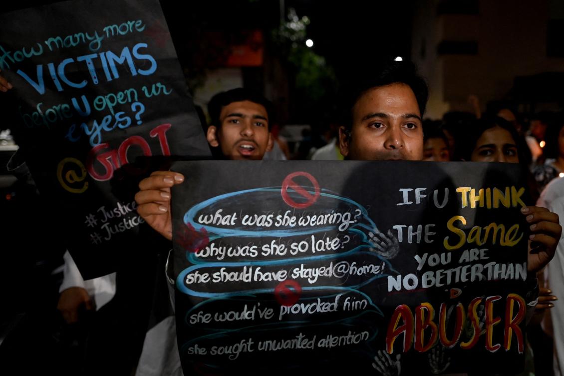 Medical professionals hold placards during a candlelight protest against the rape and murder of a doctor in India’s West Bengal state, in New Delhi, on September 4, 2024. (AFP)