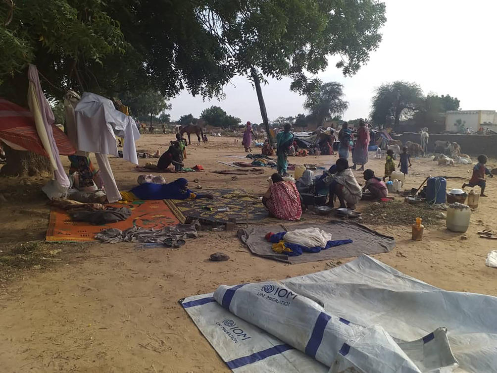 FILE — Residents displaced from a surge of violent attacks squat on blankets and in hastily made tents in the village of Masteri in west Darfur, Sudan, on July 30, 2020. (AP)