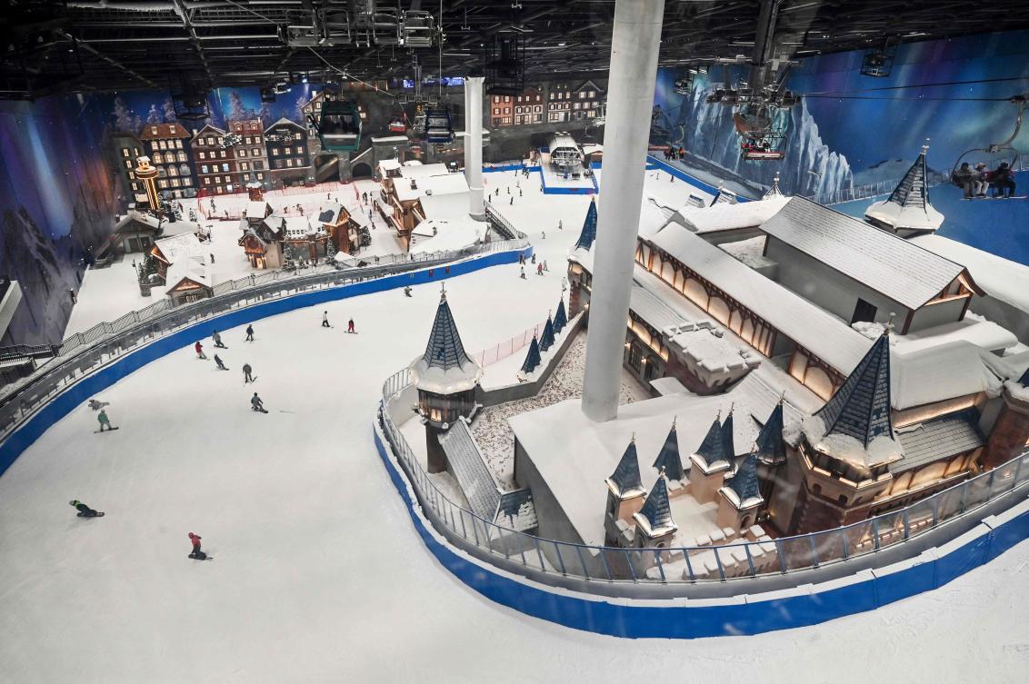 Snowboarders and skiers enjoy a run at the Shanghai L*SNOW Indoor Skiing Theme Resort, the world’s largest indoor ski resort, during the official opening day, in the Pudong district in Shanghai on September 6, 2024. (AFP)