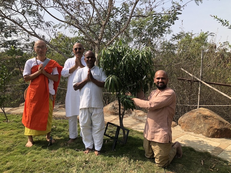 Indian activists Nitin Sonawane, Yogesh Vishwamitra and Jalandharnath Channole pose with a Buddhist friend in front of a mango tree planted from a Pakistani sapling in Pune, January 2024. (Nitin Sonawane)