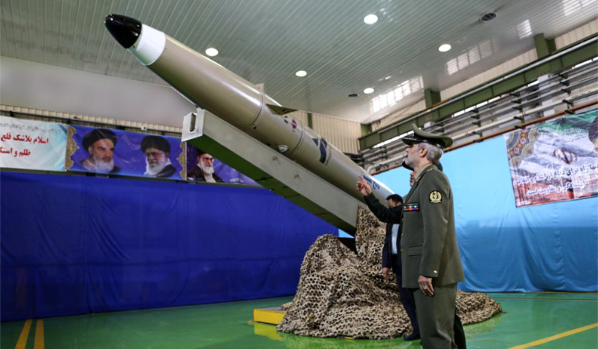 A handout picture released by Iran's Defence Ministry on August 13, 2018 shows Defence Minister, Brigadier General Amir Hatami, standing by the next generation short-range ballistic missile "Fateh Mobin", during an unveiling ceremony in the capital Tehran. (AFP)