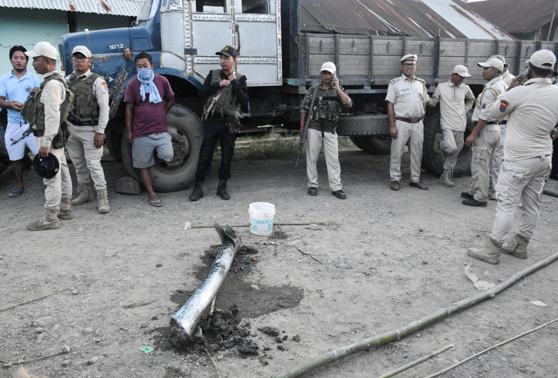 Police personnel and locals stand near the remains of a missile after it struck in Moirang, Manipur, India, September 6, 2024. (Reuters)