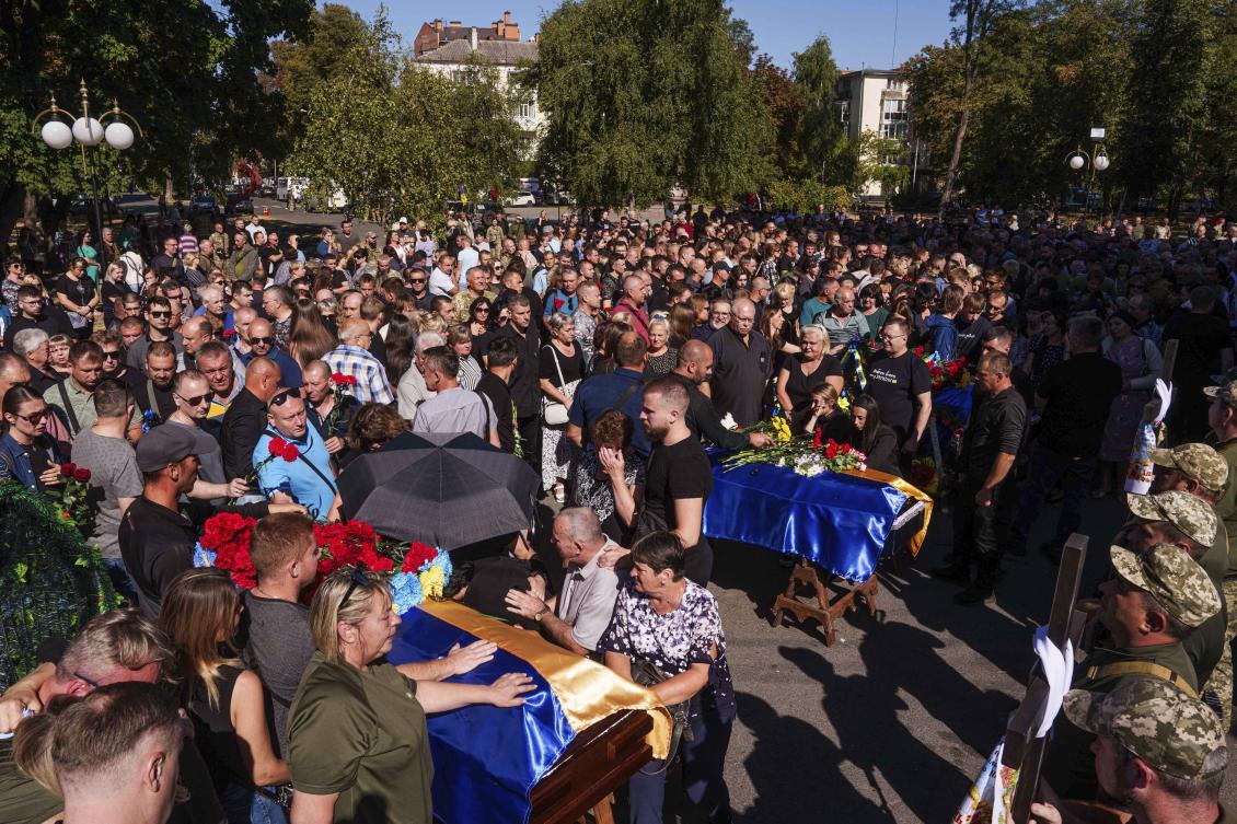 Relatives and friends mourn near the coffins of six Ukrainian servicemen killed in a Russian rocket attack at a Ukrainian military academy, during their funeral ceremony in Poltava, on Sept. 7, 2024. (AP)