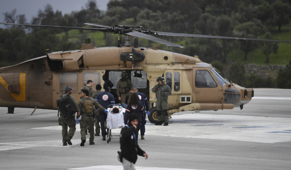 An Israeli medical team evacuate a person injured by a rocket fired from Lebanon, at Ziv hospital in Safed, northern Israel, Wednesday, Feb. 14, 2024. (AFP)