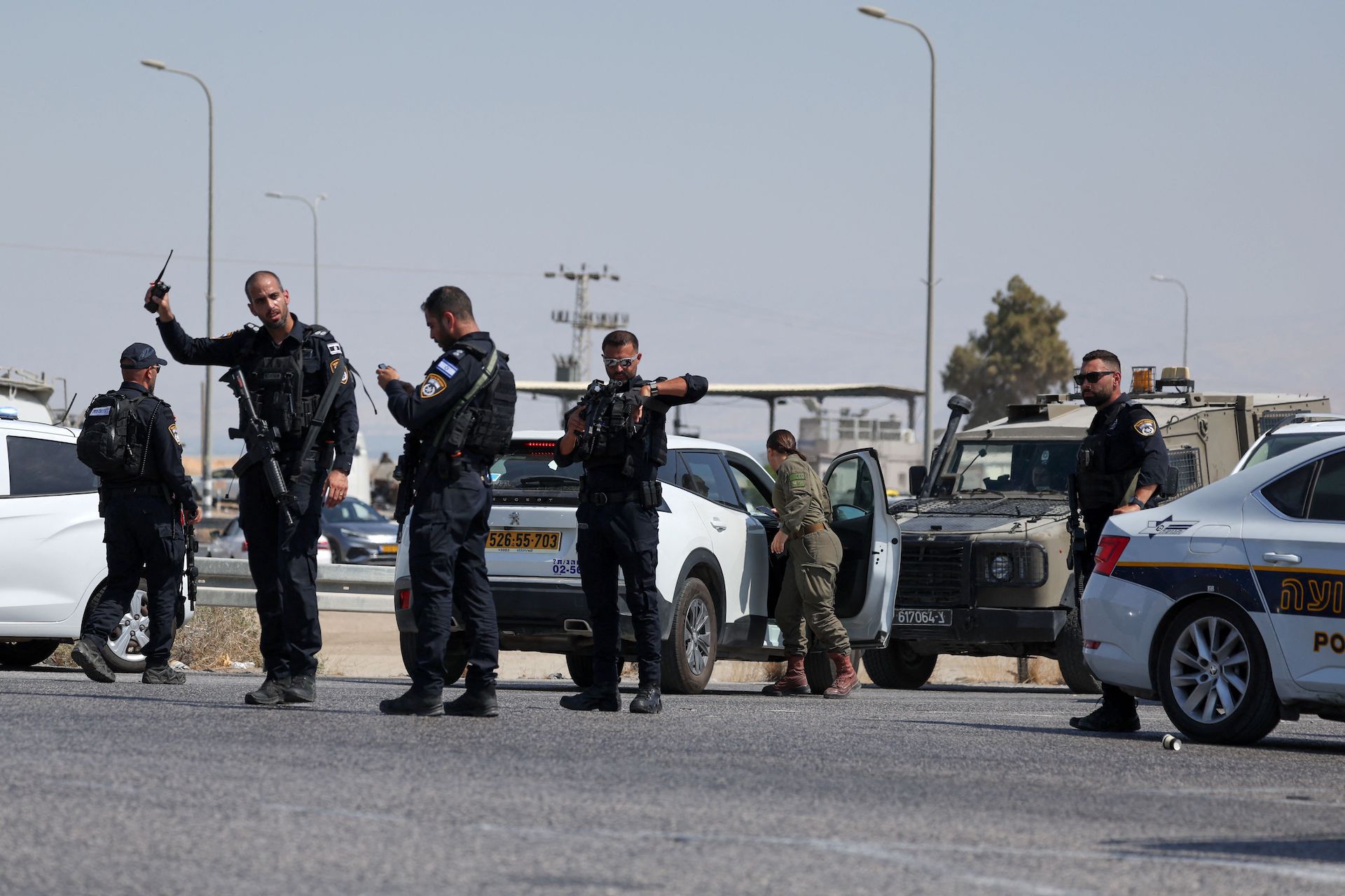 Israeli security forces gather at the scene of a reported attack near the Allenby Crossing between the occupied West Bank and Jordan on September 8, 2024, where the Israeli military said a truck driver opened fire, killing three Israelis. (AFP)
