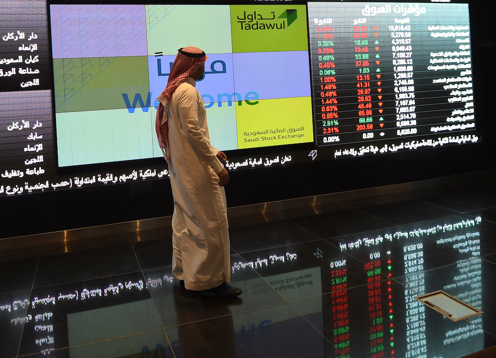 A Saudi investor monitors the exchange board at the Saudi Stock Exchange, or Tadawul, in the capital Riyadh. File/AFP