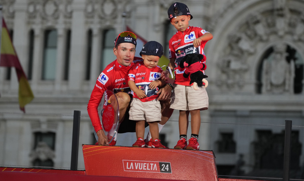 Primoz Roglic of Slovenia poses with his children and the trophy after winning La Vuelta cycling race during the last stage in Madrid Sunday. (AP)