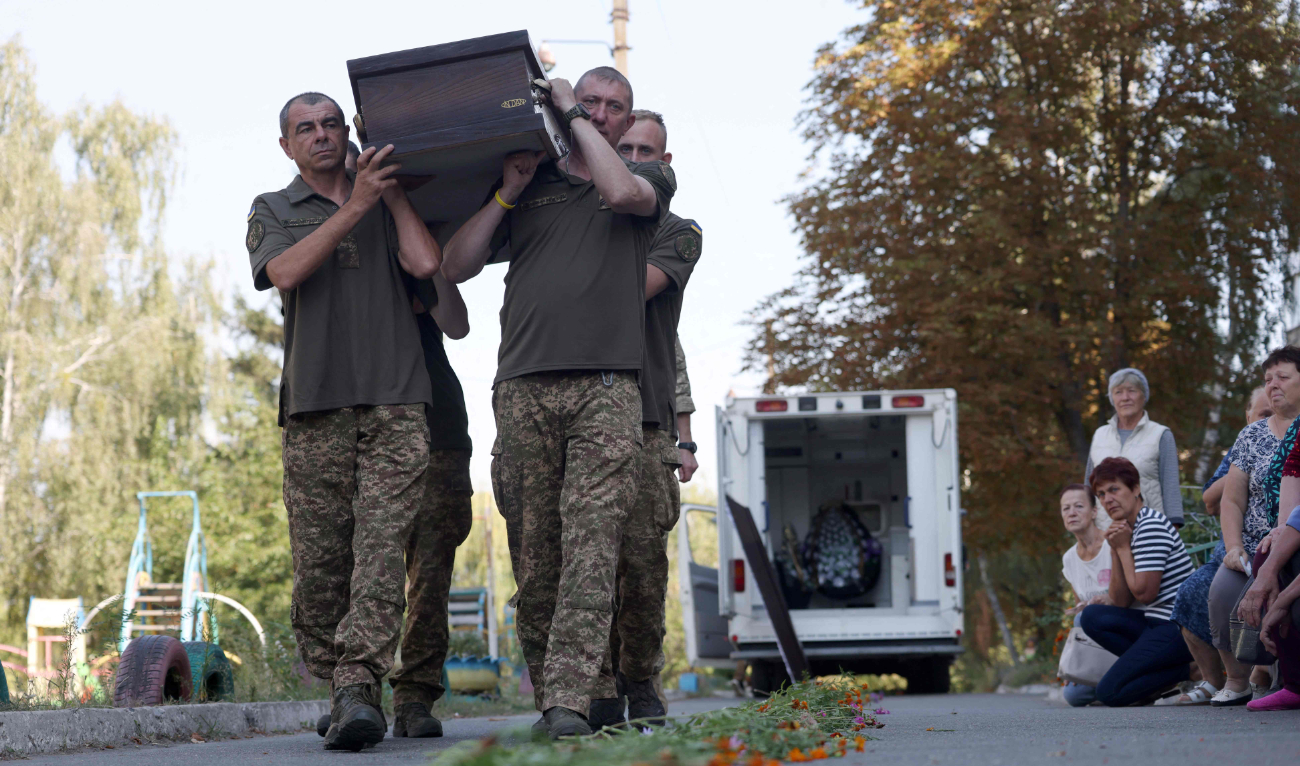 Ukrainian servicemen carry the coffin of their comrade in Bucha, amid Russia’s war with Kyiv. (AFP/File)