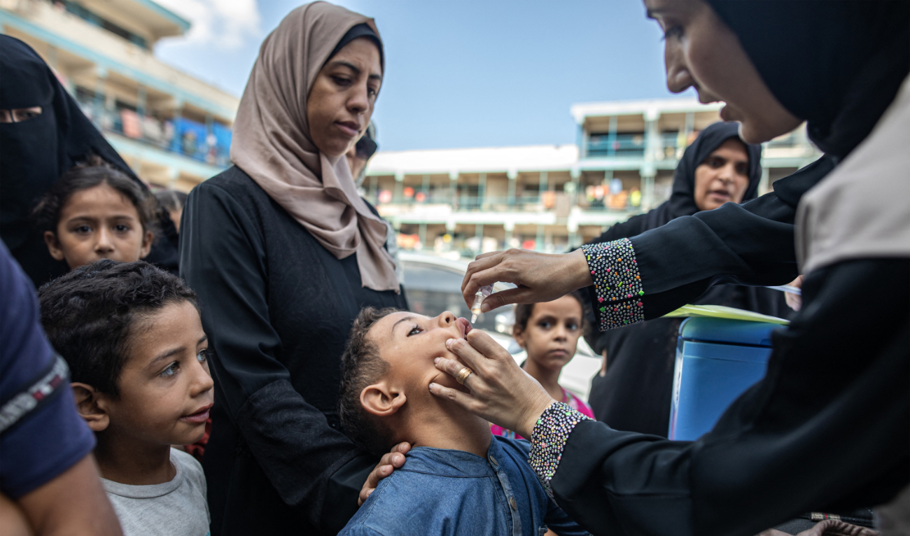 A child receives a vaccination for polio at a makeshift camp for people displaced by conflict in a school run by the UNRWA in Khan Yunis in the southern Gaza Strip on September 5, 2024. (AFP)