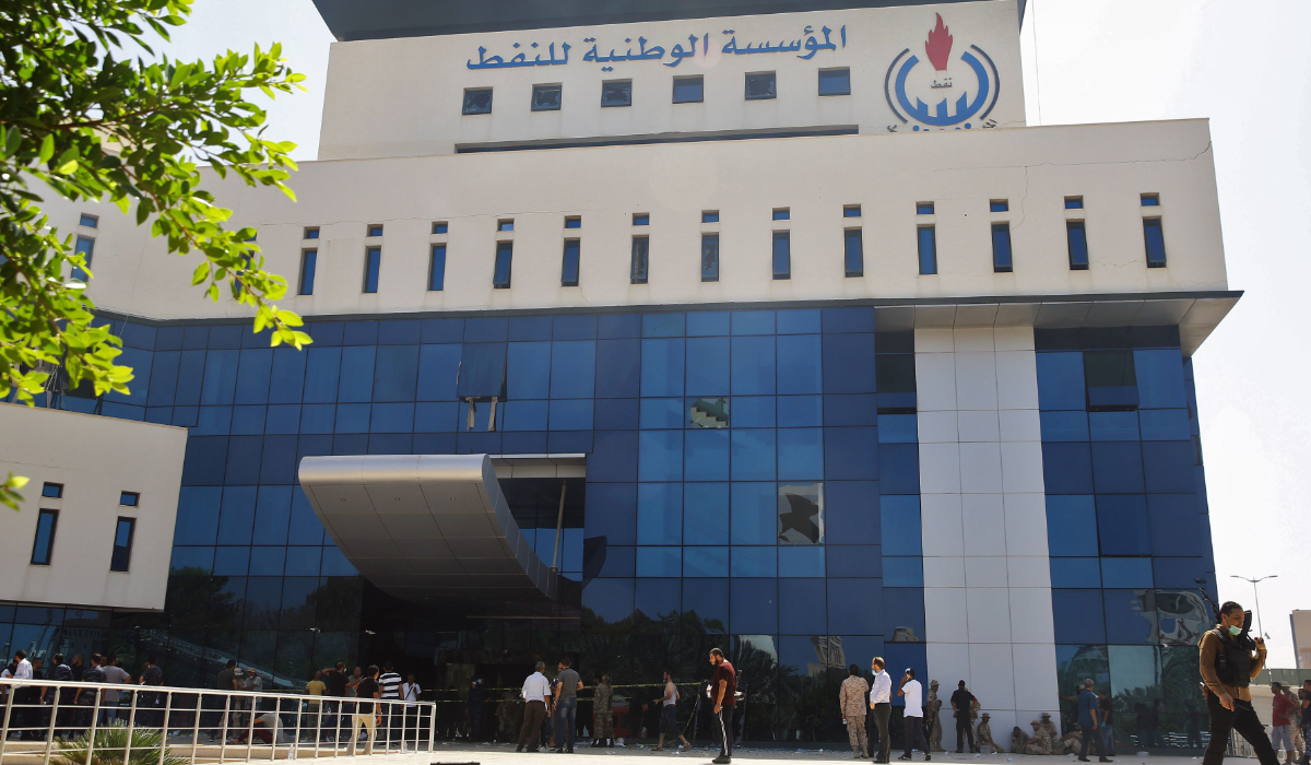 Onlookers gather in front of the headquarters of Libya's National Oil Company in the capital Tripoli on September 10, 2018. (AFP)