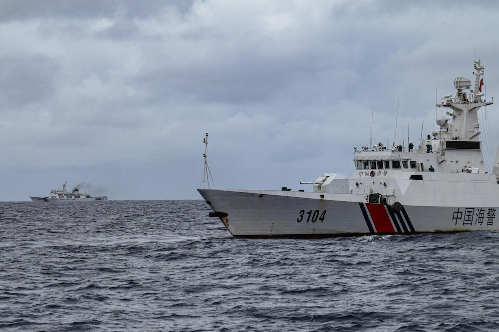 Above, China Coast Guard ships are seen from the Philippine Coast Guard vessel BRP Cabra during a supply mission to Sabina Shoal in disputed waters of the South China Sea on Aug 26, 2024. (AFP)