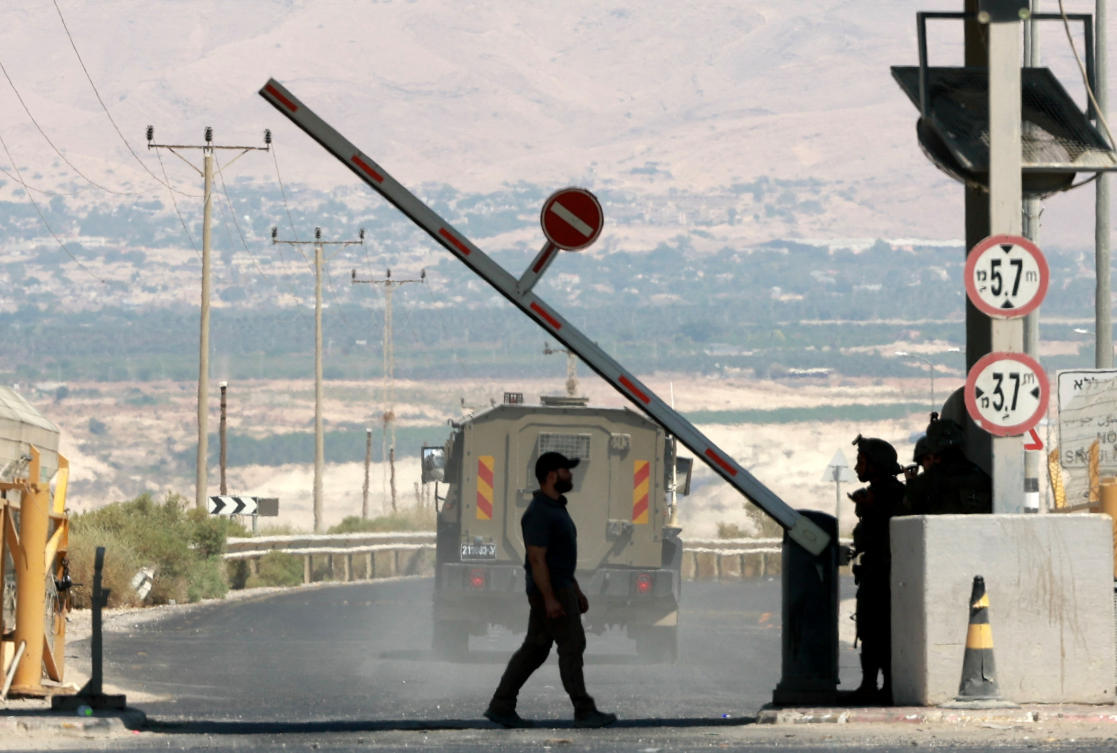 A man walks at a barrier, at the Allenby Bridge Crossing between the West Bank and Jordan, following a shooting incident at the crossing in the Israeli-occupied West Bank, September 8, 2024. (Reuters)