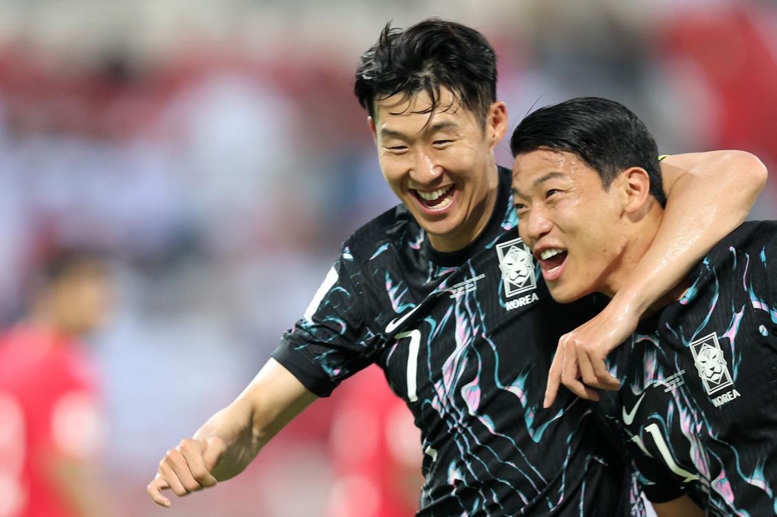 South Korea’s forward and captain Son Heung-min celebrates with his striker Hwang Hee-chan after the latter scored a goal during the 2026 FIFA World Cup Asian qualification match against Oman in Muscat on Sept. 10, 2024. (AFP)