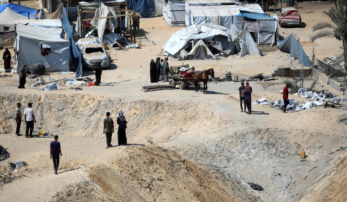 Palestinians check the site of Israeli strikes on a makeshift displacement camp in Mawasi in Khan Yunis in the southern Gaza Strip on September 10, 2024, amid the ongoing war between Israel and Palestinian militant group Hamas. (AFP)