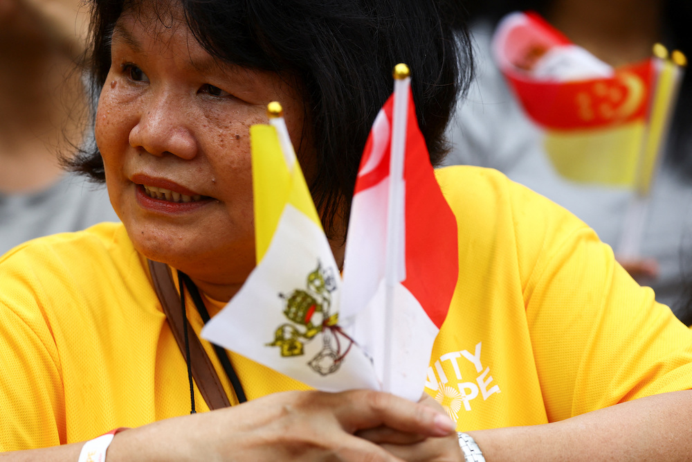 People wait for Pope Francis on the day of his visit to Singapore, during the last leg of his apostolic visit to Asia, in Singapore on Sept. 11, 2024. (Reuters)