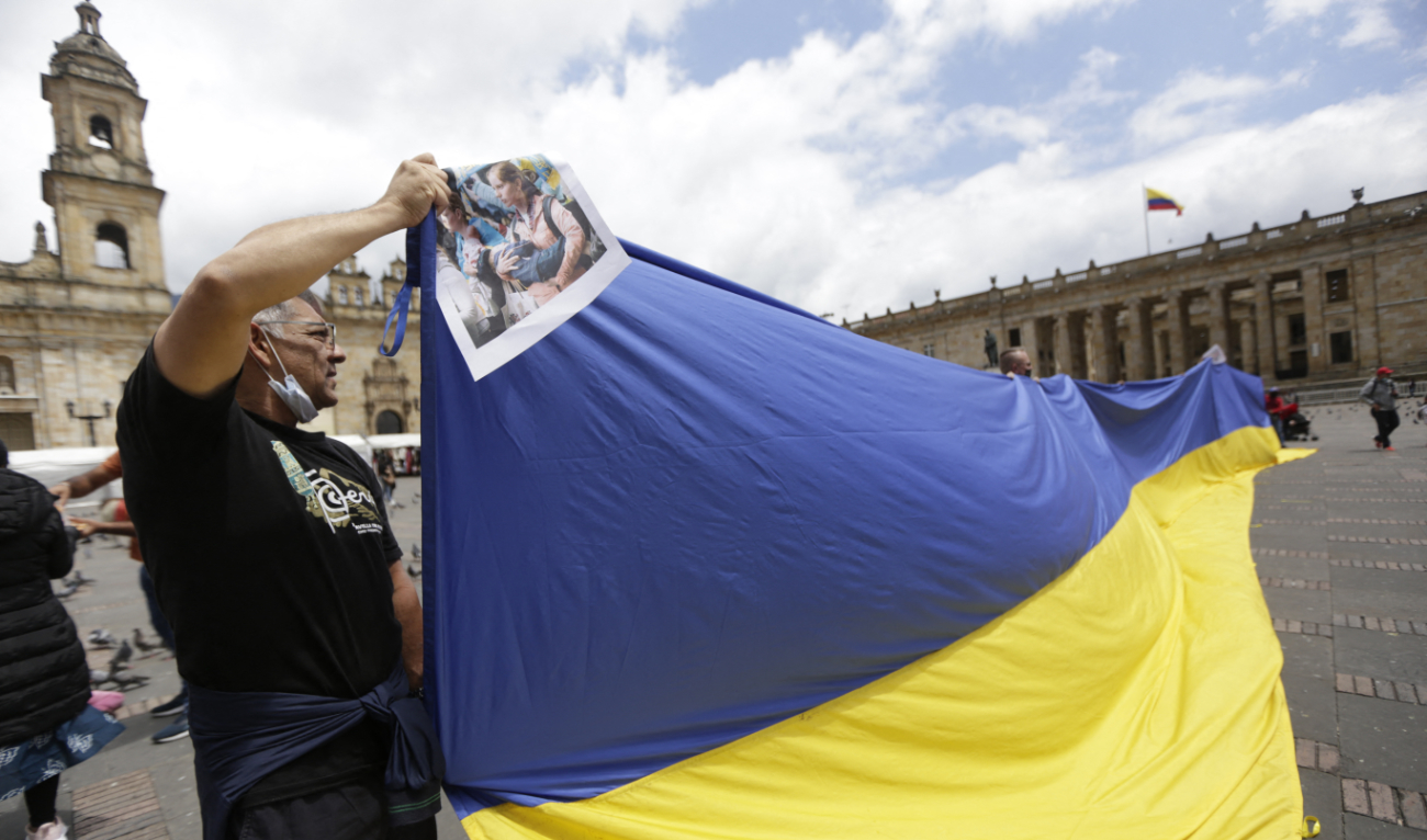 A man holds a large Ukrainian during a protest against Russian attacks on Ukraine at the Bolivar square in Bogota on April 2, 2022. (AFP/File)