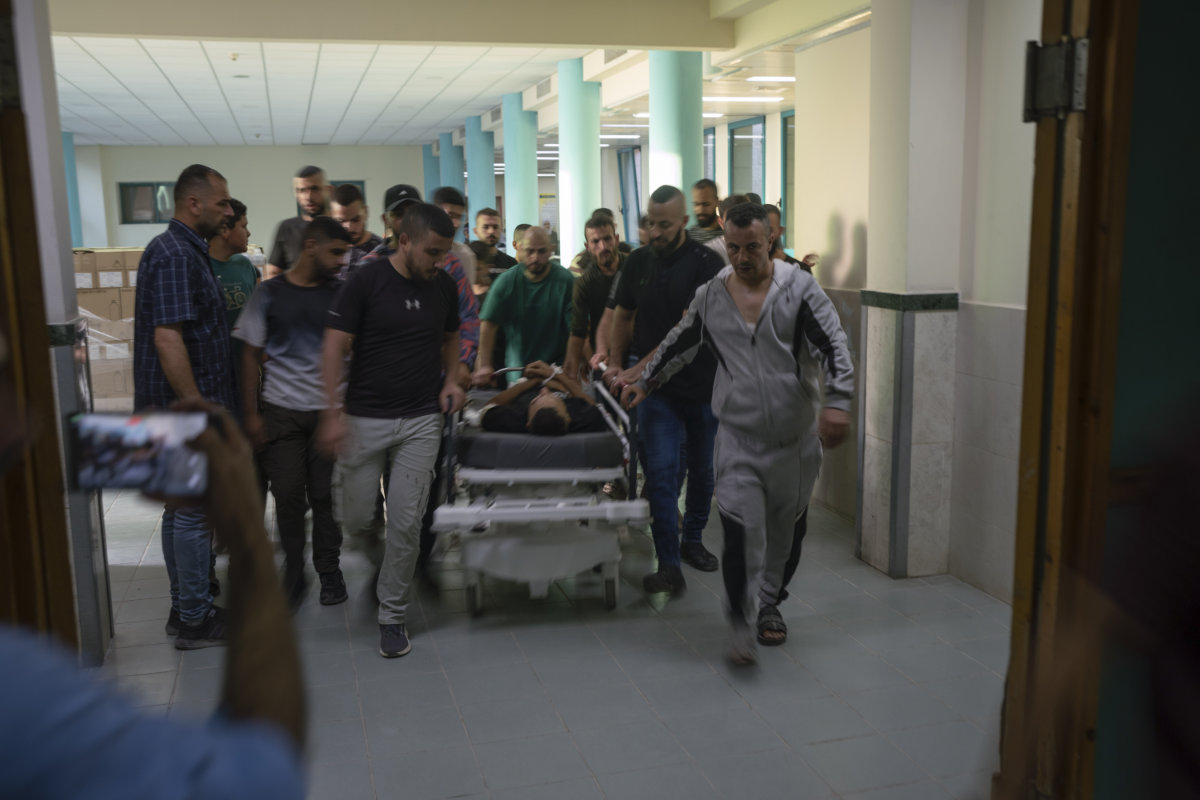 The body of Odei, a 22-year-old Palestinian militant, is carried into a morgue at the hospital in Jenin, West Bank, on June 6, 2024. (AP)