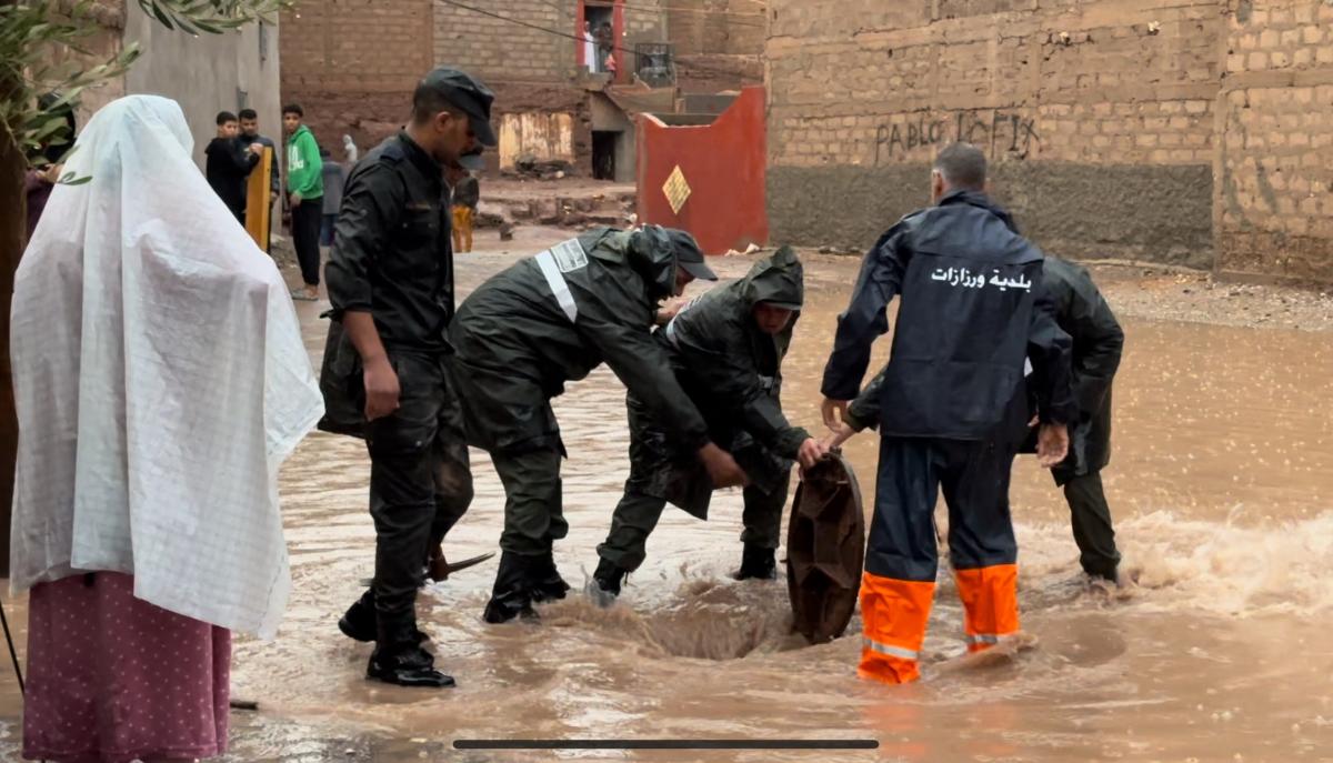 Moroccan municipal workers and members of Auxiliary Forces help drain a road in a flooded neighborhood in the city of Ouarzazate on September 7, 2024. (AFP)