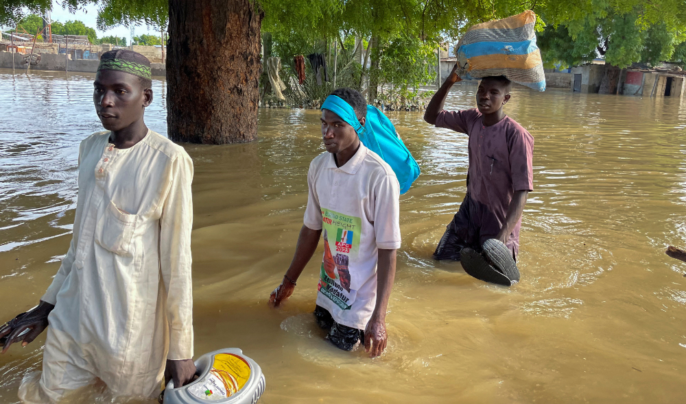 Residents leave flooded areas with their belongings during rescue operations in Maiduguri, northern Borno state, Nigeria. (Reuters)