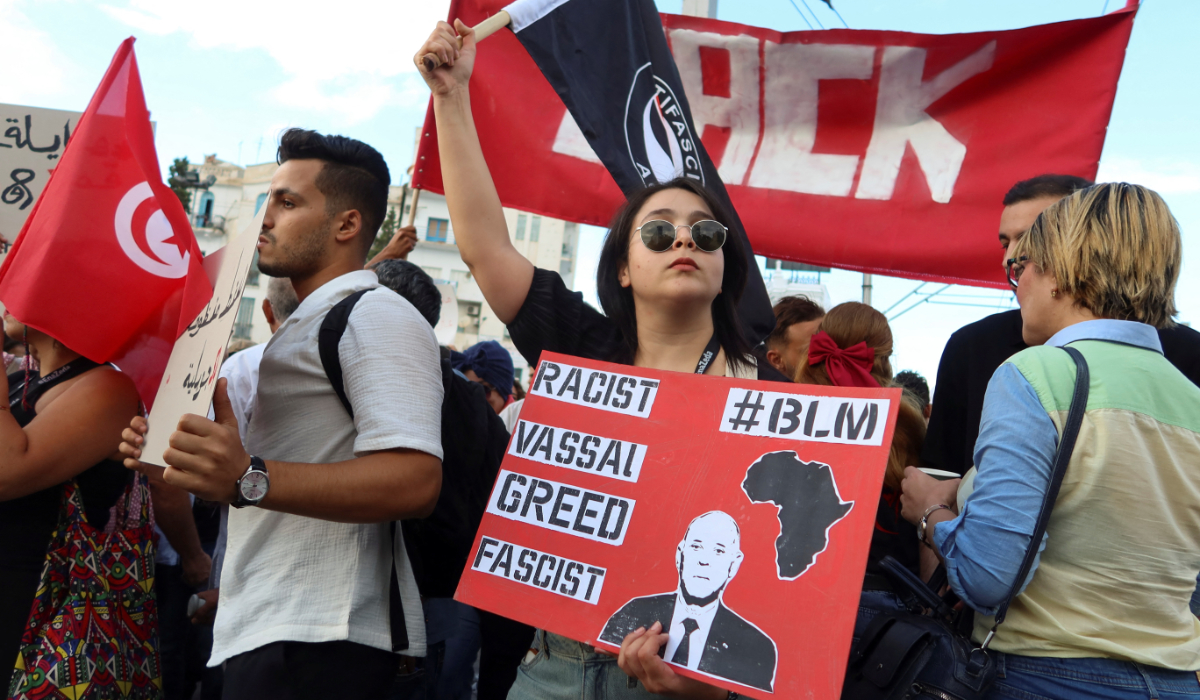 A person holds a sign during a protest against President of Tunisia Kais Saied, whom demonstrators accuse of trying to rig the October 6 presidential election by detaining and intimidating his rivals, in Tunis, Tunisia, September 13, 2024. (REUTERS)