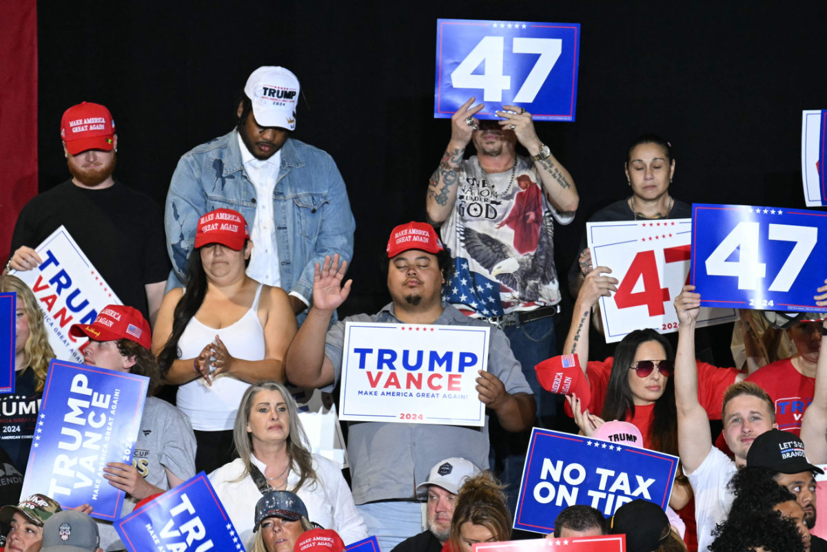 Supporters of Republican presidential candidate Donald Trump pray at the start of a campaign rally at the Expo World Market Center in Las Vegas, Nevada, on September 13, 2024. (AFP) e