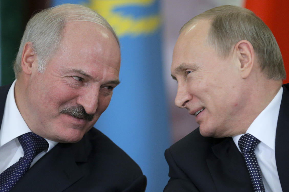FILE - Russian President Vladimir Putin, right, and his Belarus counterpart, Alexander Lukashenko, talk at an economic summit in the Kremlin, in Moscow, Russia, on Dec. 23, 2014. (AP)