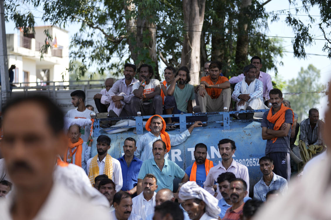 Bhartiya Janta Party (BJP) supporters sit on a water tank and listen to the party candidates during a campaign rally for the upcoming Jammu and Kashmir Assembly elections at Nagrota outskirts of Jammu, India, Thursday, Sep.12, 2024.(AP Photo/Channi Anand)