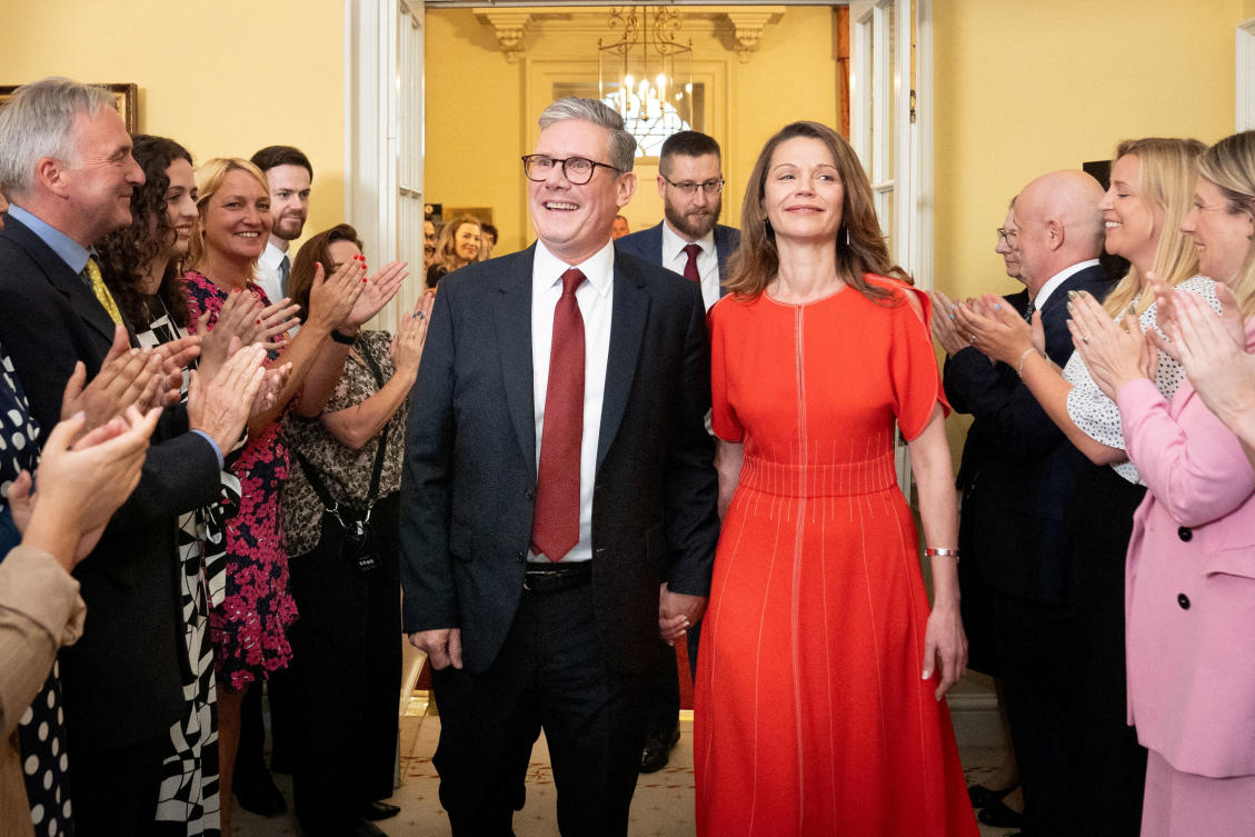 Newly elected Prime Minister Sir Keir Starmer and his wife Victoria Starmer are clapped in by staff as they enter his official London residence at No 10 Downing Street for the first time after the Labour Party won a landslide victory at the 2024 General Election, in London. (Reuters)