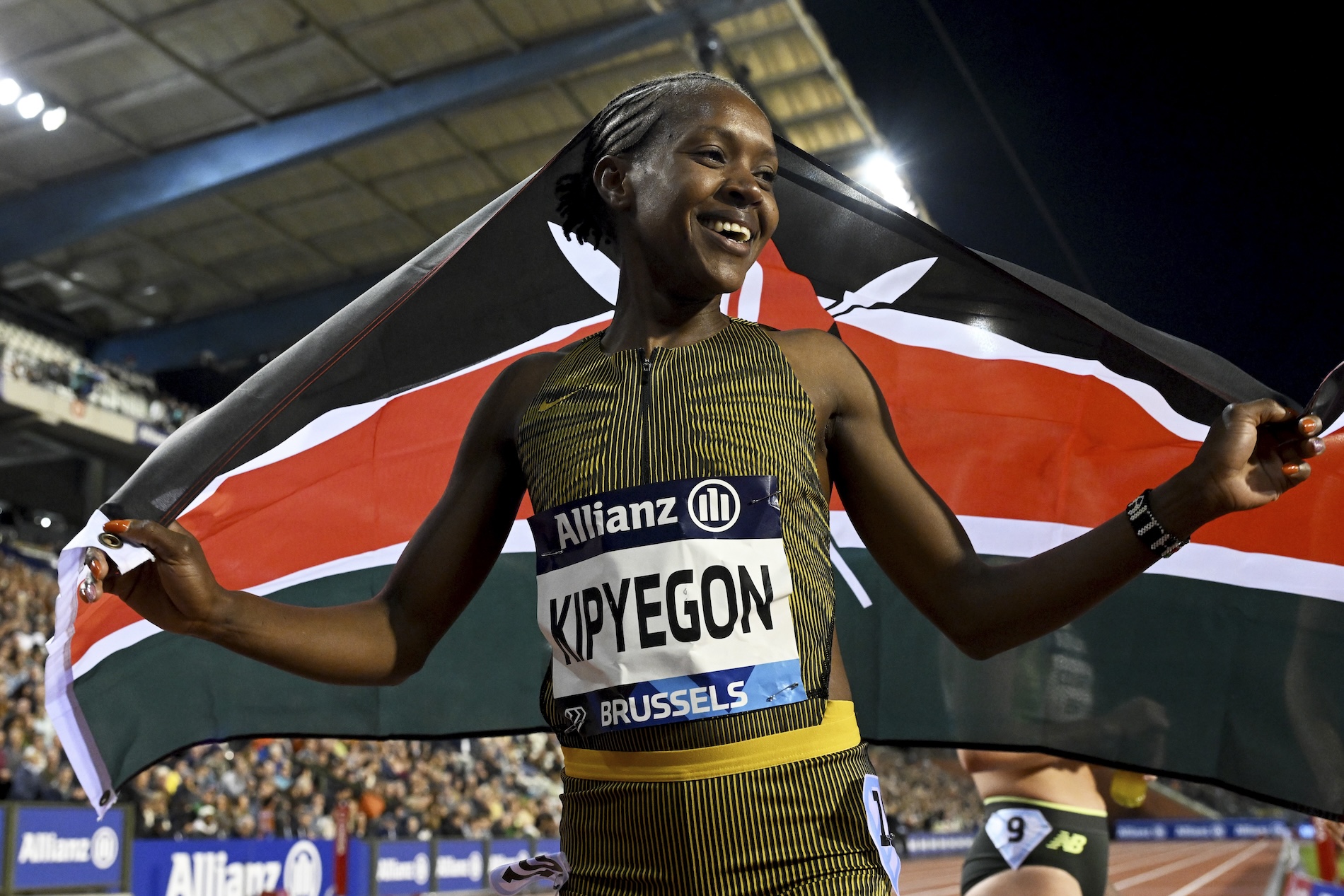 Faith Kipyegon, of Kenya, celebrates with her national flag after winning the women's 1500 meters during the Diamond League final 2024 athletics meet in Brussels Saturday. (AP)