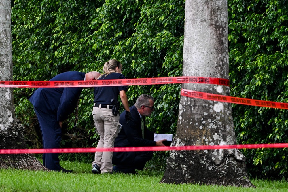 Law enforcement officers are seen at the crime scene outside the Trump International Golf Club in West Palm Beach, Florida. (AFP)