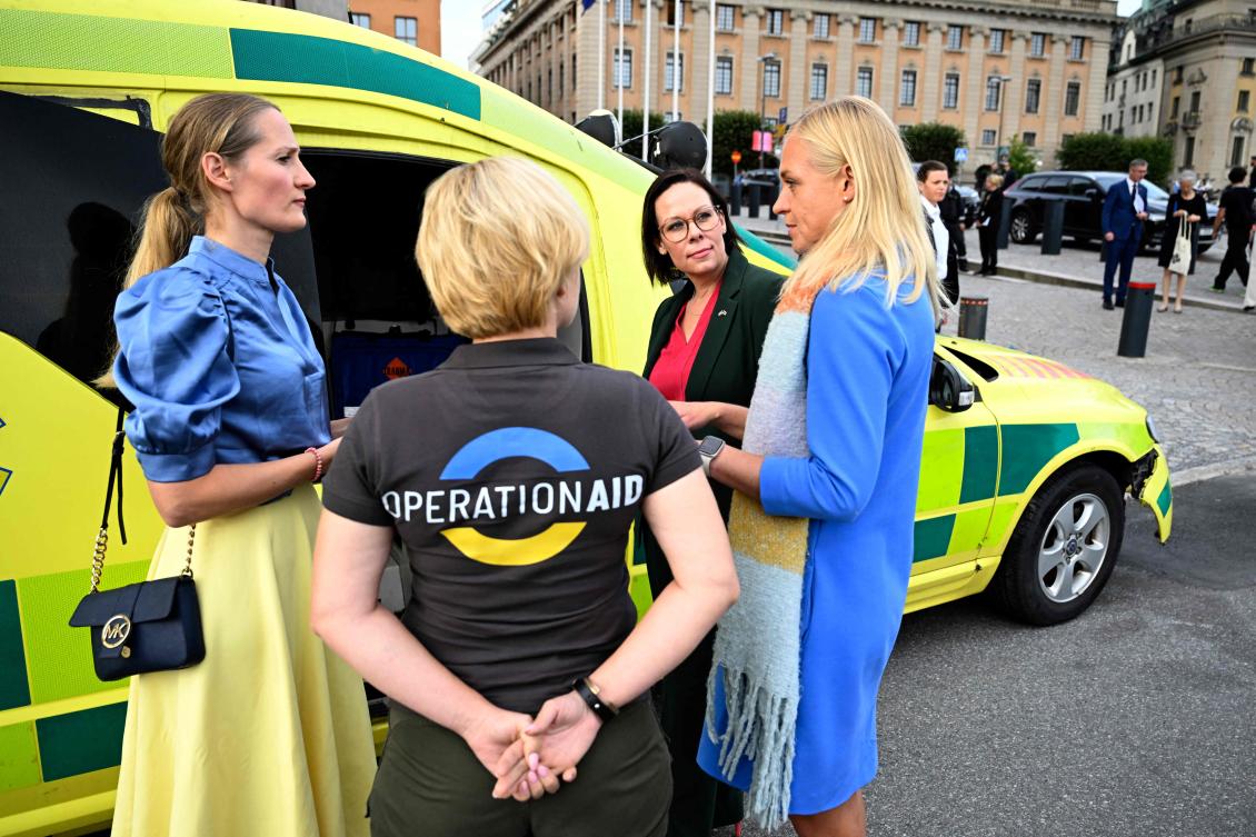 Sweden's Foreign Minister Maria Malmer Stenergard (2nd R) her Finnish counterpart Elina Valtonen (R) meet the founder of the OperationAid organisation Elly Reinolds (L) in front of the Ministry of Foreign Affairs at Gustaf Adolfs square in Stockholm, Sweden. (File/AFP)