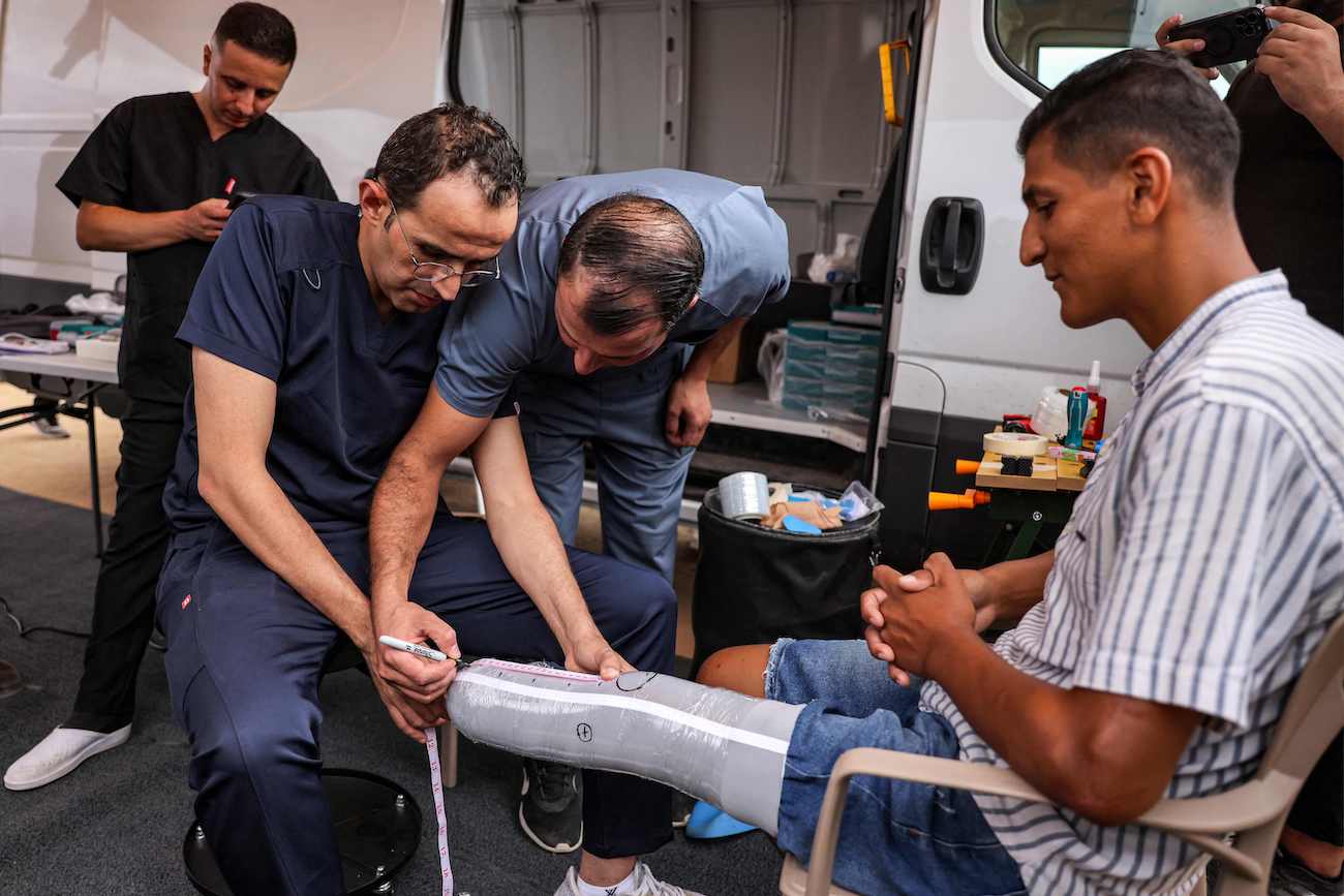 A man with an above-the-knee amputation is fitted with a new prosthetic limb at a Jordanian field hospital in Khan Yunis in the southern Gaza Strip on September 17, 2024. (AFP)