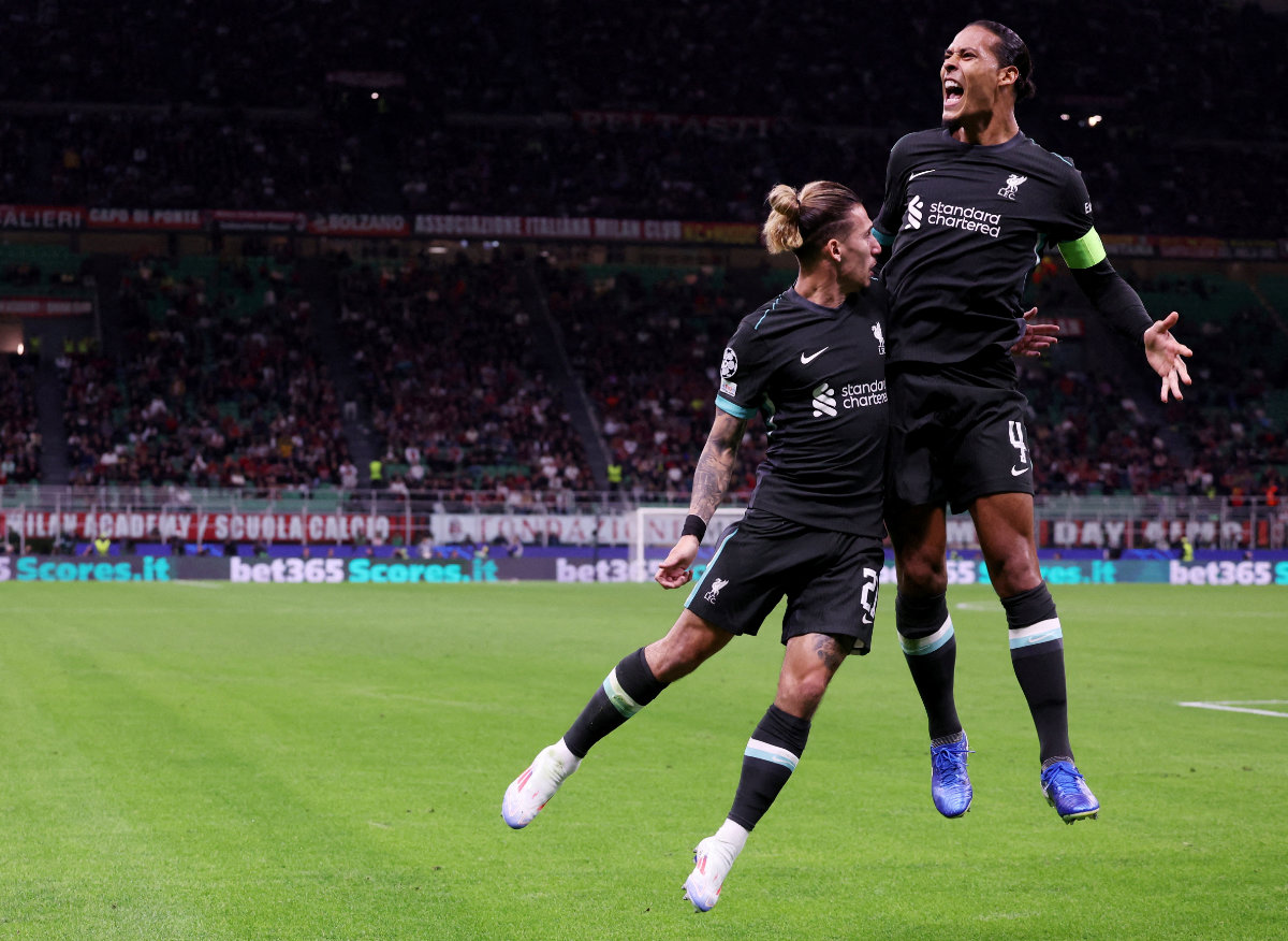 Liverpool's Virgil van Dijk celebrates scoring their second goal with Kostas Tsimikas during their soccer match between AC Milan and Liverpool at San Siro in Milan, Italy on September 17, 2024. (Reuters)