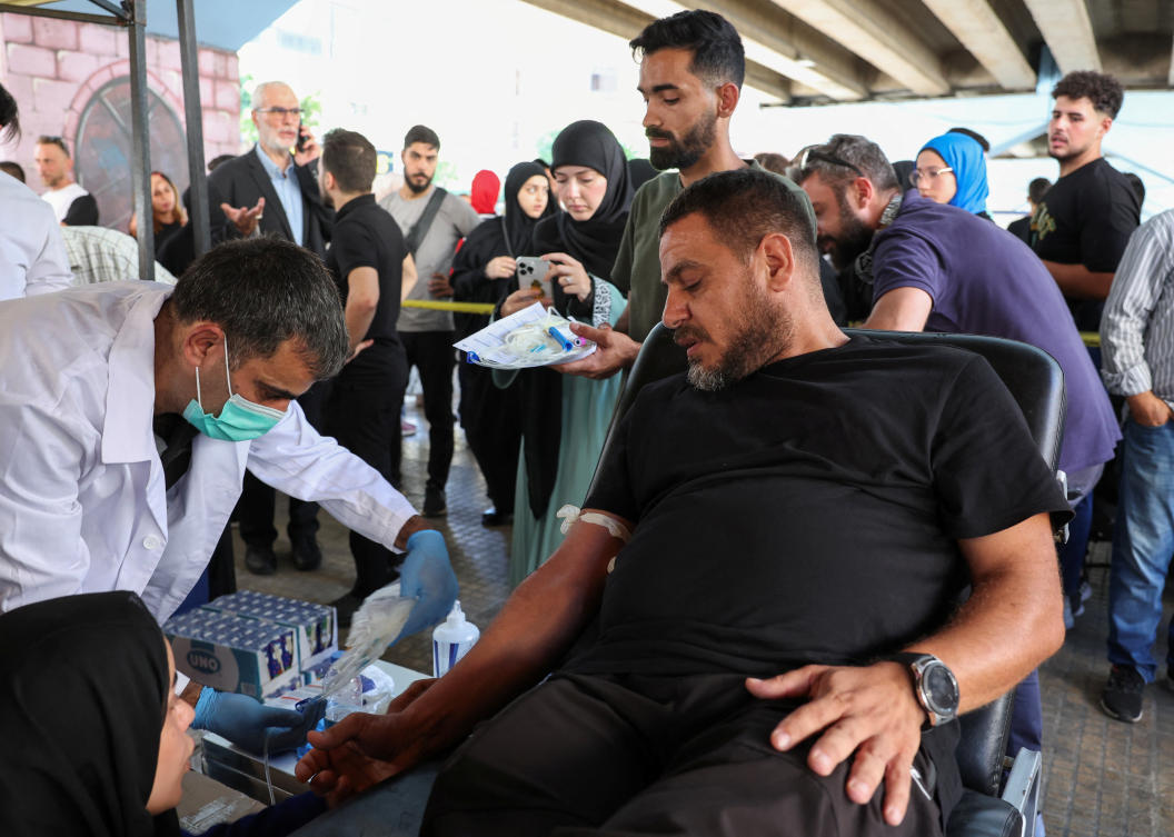 A man donates blood, following pager detonations across Lebanon on Tuesday, in Beirut suburbs on Sept. 18, 2024. (Reuters)