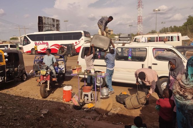 Sudanese refugees wait for hours in the scorching sun outside UNHCR’s Cairo office, hoping to receive asylum identification cards that would allow them to stay in Egypt after fleeing Sudan's war. (AFP/File)