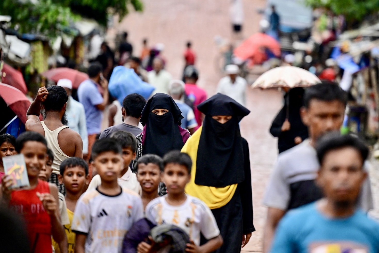 Rohingya refugees walk in a market, at a refugee camp in Ukhia on Sept. 12, 2024. (AFP)