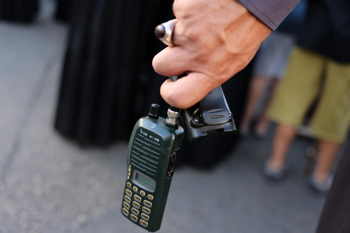 A man holds a walkie talkie device after he removed the battery during the funeral of persons killed when hundreds of paging devices exploded in a deadly wave across Lebanon the previous day, in Beirut's southern suburbs on September 18, 2024. (AFP)