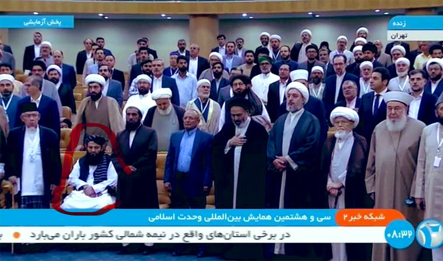 The screenshot shared by journalist Ihsanullah Tipu Mehsud on September 19, 2024, shows an Afghan official (encircled) sitting during the playing of Iran’s national anthem at an event in Tehran. (Ihsanullah Tipu Mehsud/X)