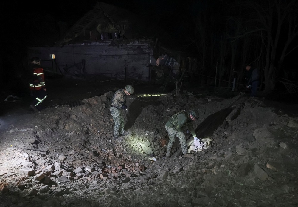 Police experts work at a site of a Russian air strike, amid Russia's attack on Ukraine, in Kharkiv, Ukraine. (Reuters)