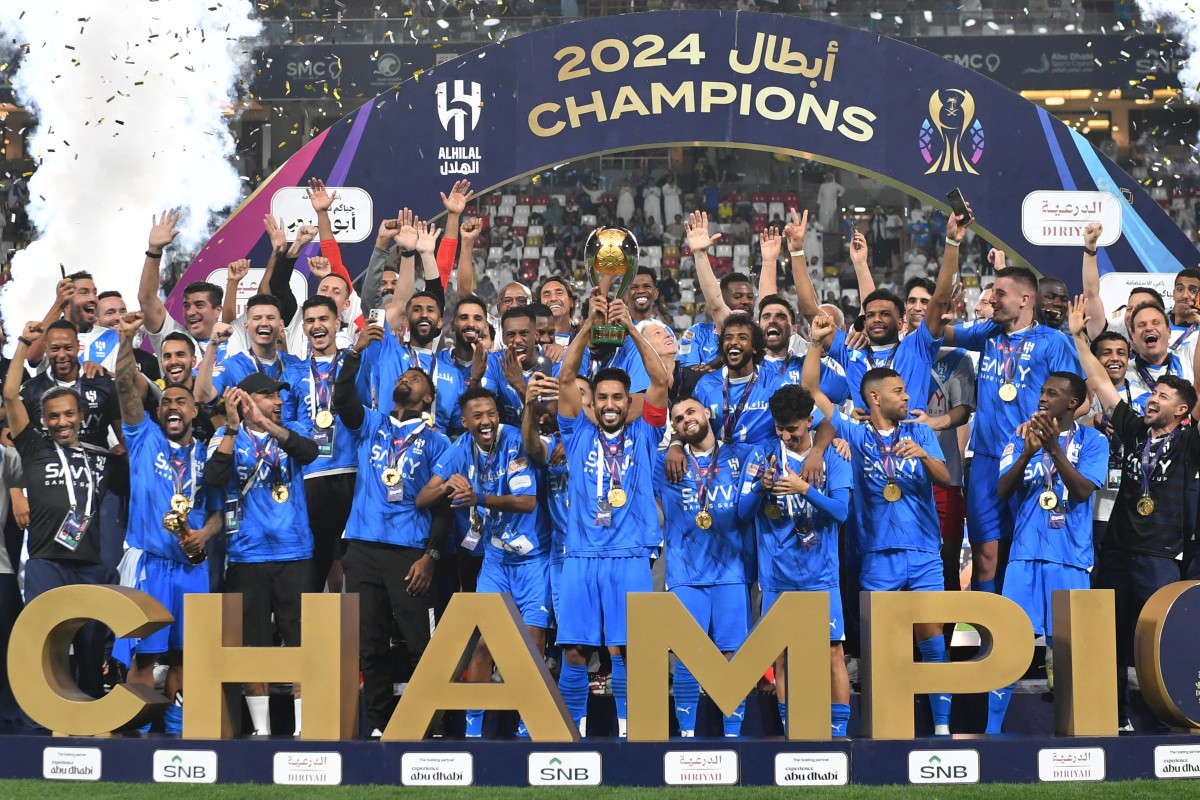 Hilal's players celebrate with the trophy after winning the Saudi Super Cup final football match between Al-Ittihad and Al-Hilal at the Mohammed bin Zayed Stadium in Abu Dhabi on April 11, 2024. (AFP)