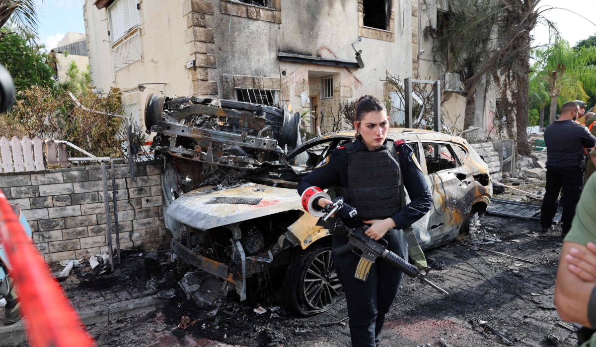 A member of the Israeli security forces stands guard inside a cordoned-off area in Kiryat Bialik in the Haifa district of Israel, targeted by a reported strike by Lebanon's Hezbollah on September 22, 2024. (AFP)