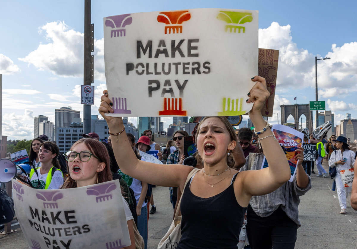 Activists cross the Brooklyn Bridge during a Youth Global Climate demonstration ahead of the UN Climate week and General Assembly in New York City on September 20, 2024. (AFP)