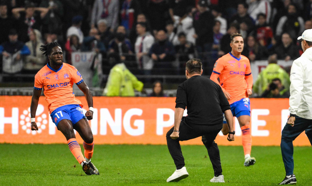 Marseille's English forward Jonathan Rowe (L) after scoring his team's third goal during the French L1 football match between Olympique Lyonnais and Olympique de Marseille at The Groupama Stadium in Decines-Charpieu, central-eastern France, on Sunday. (AFP)