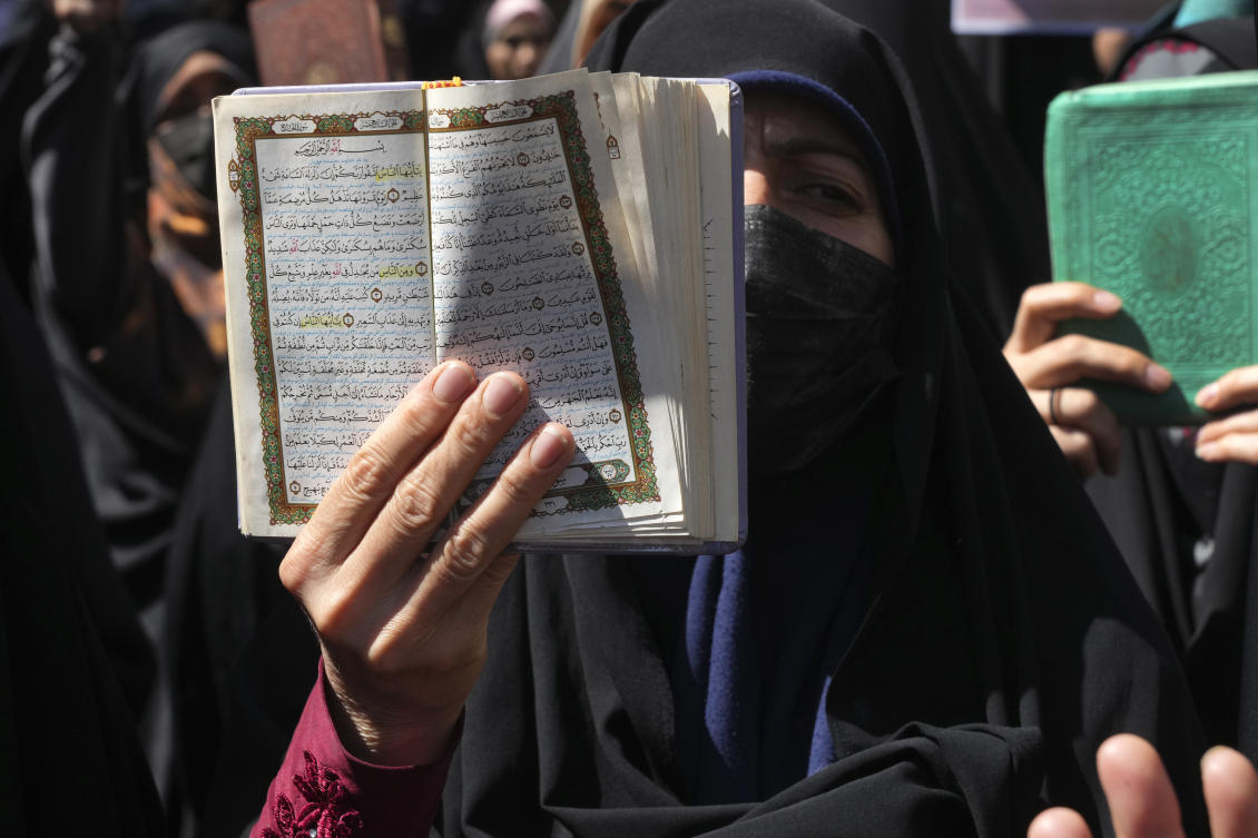 Demonstrator holds up a copy of the Quran during a protest of the burning of a Quran in Sweden, in front of the Swedish Embassy in Tehran, Iran. (File/AP)