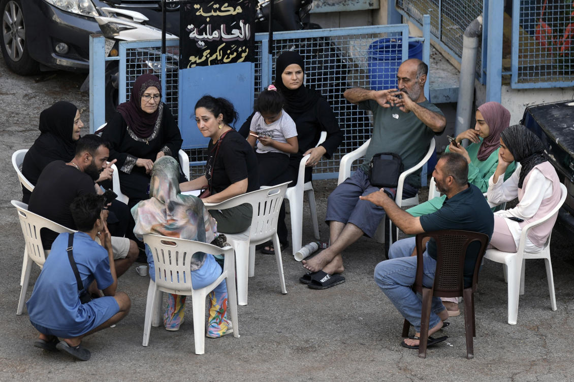 Residents fleeing the Israeli airstrikes in the south, sit in a school turned into a shelter in Beirut, Tuesday, Sept. 24, 2024. (AP Photo/Bilal Hussein)