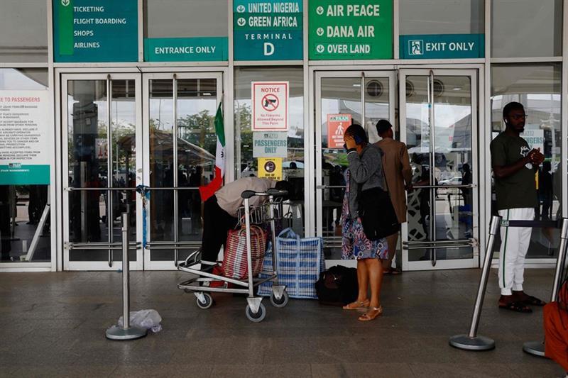 Passengers react while stranded at the gate of the Nnamdi Azikiwe International Airport after the Nigerian unions began an indefinite strike in Abuja, on June 3, 2024. (AFP)