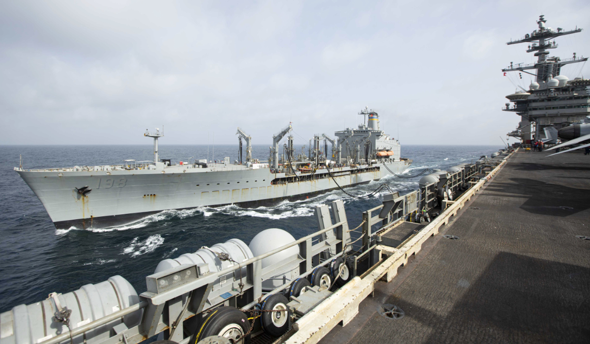 This handout photo from the U.S. Navy shows the Henry J. Kaiser-class fleet replenishment oiler USNS Big Horn sailing alongside the aircraft carrier USS Abraham Lincoln on Sept. 11, 2024, at an undisclosed location at sea in the Middle East. (AP)