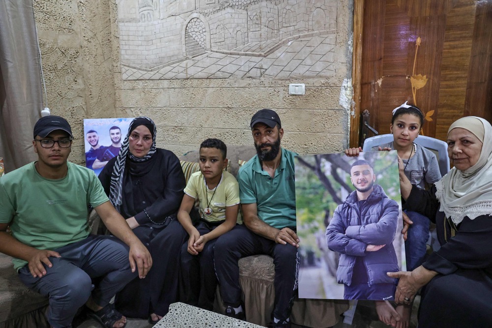 he family of Wael Masha, 18, killed in an Israeli airstrike on the Balata camp. (AFP)